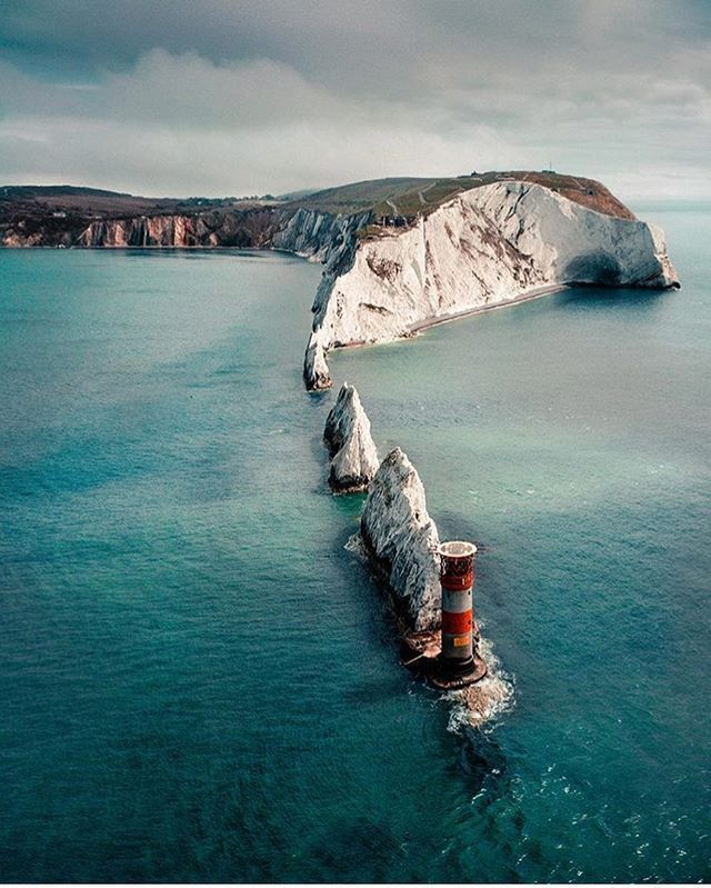 a large body of water with some white cliffs in the background