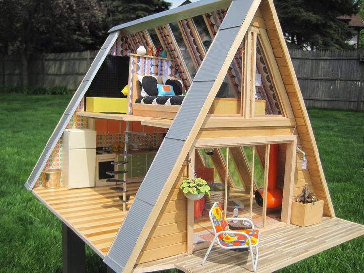 a house made out of wood sitting in the grass