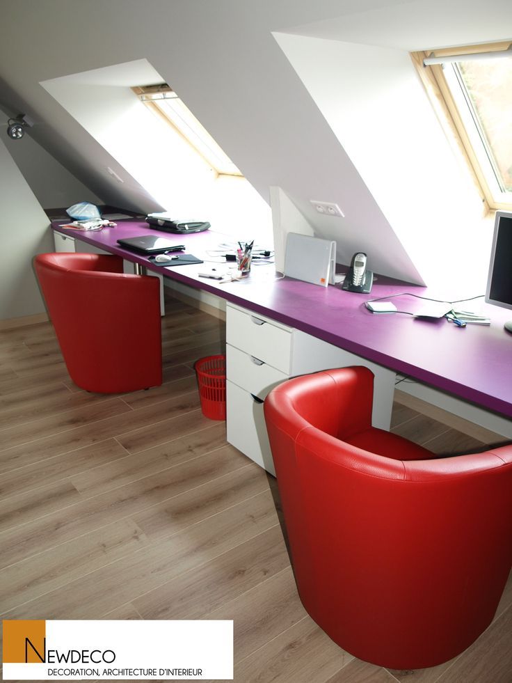 an office with two red chairs and a purple desk