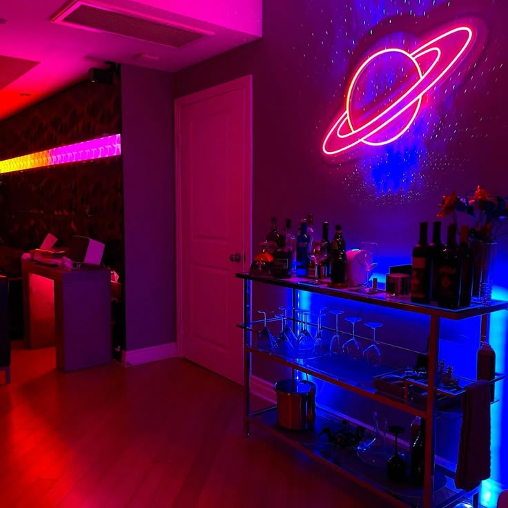 a room with a bar and neon lights on the wall, in front of a door