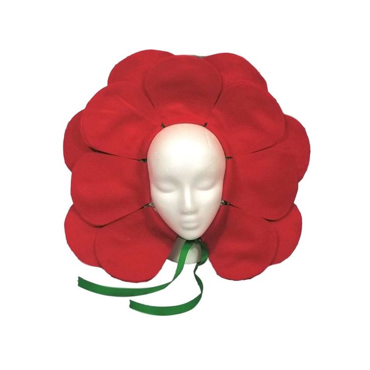 a white mannequin head with a red flower on it's head and green ribbon