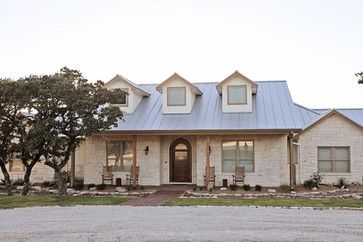 a large brick house with a metal roof