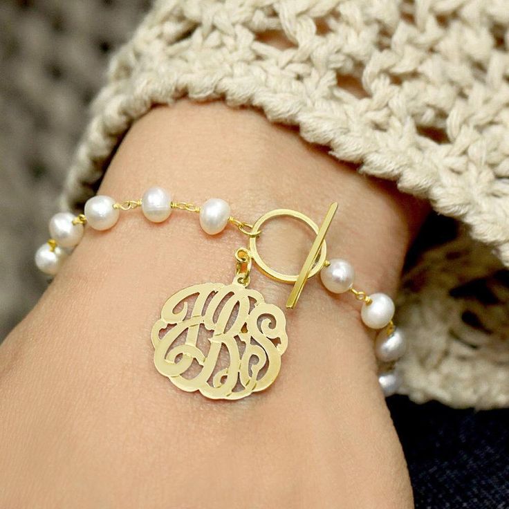 Description This exquisite personalized monogram pearl bracelet is made of sterling silver.  It is a must have in any wardrobe. The length of the bracelet is 7". Chain type - fresh water pearl.  Product Specifications:  Metal type:  sterling silver Chain type:  pearls                         Chain length:  7 in. Pendant diameter:   choice of  5/8 - 1 1/4 inch. Classic Personalized Pearl Jewelry, Elegant White Monogram Jewelry, Classic Personalized Pearl Bracelet, Personalized Classic Pearl Bracelet, Silver Pearl Bracelet With Pearl Charm For Mother's Day, Elegant Personalized Adjustable Pearl Bracelet, Elegant Adjustable Personalized Pearl Bracelet, Adjustable Personalized Pearl Bracelet, Elegant Personalized Round Pearl Bracelet