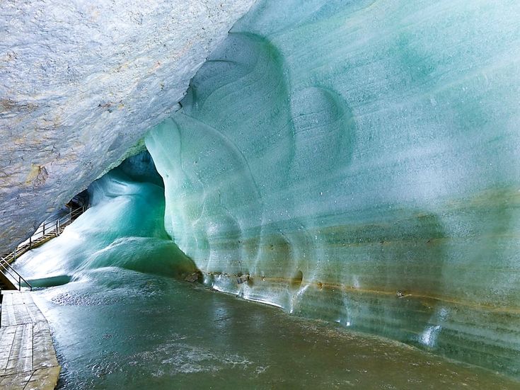 an ice cave with water flowing from it