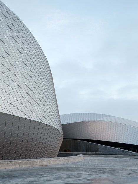 the exterior of a modern building with curved walls