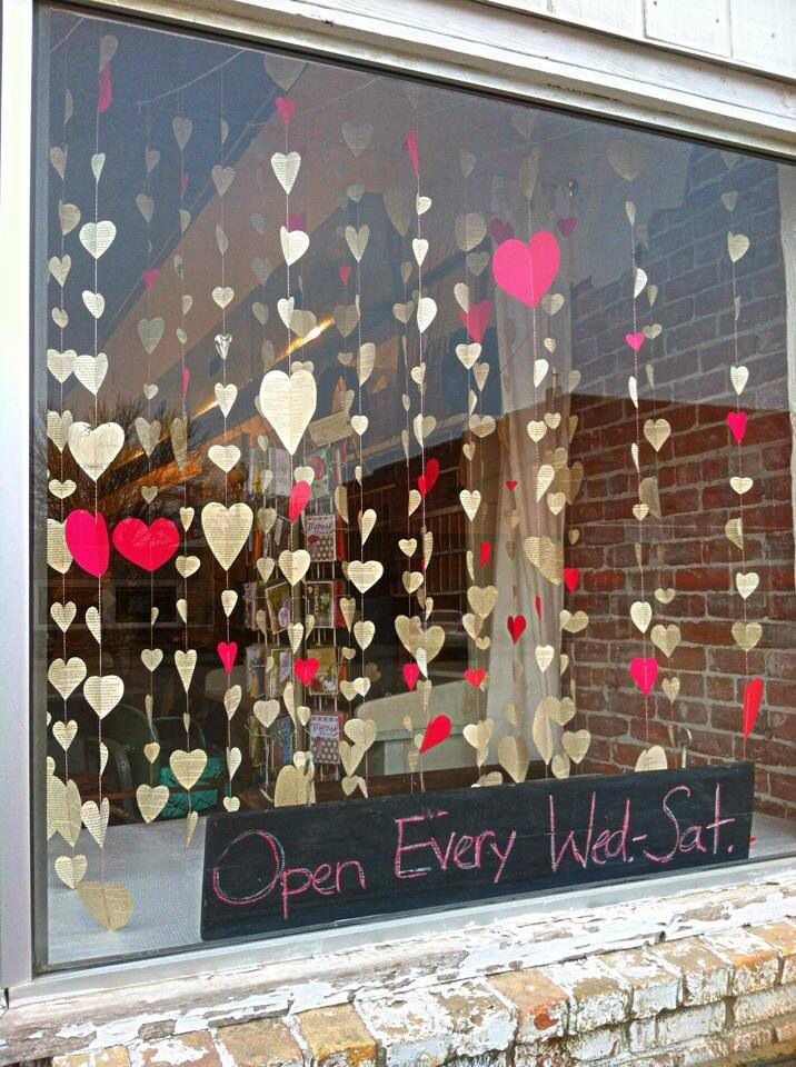 an open window with hearts hanging from it