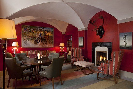 a living room filled with furniture and a fire place next to a painting on the wall