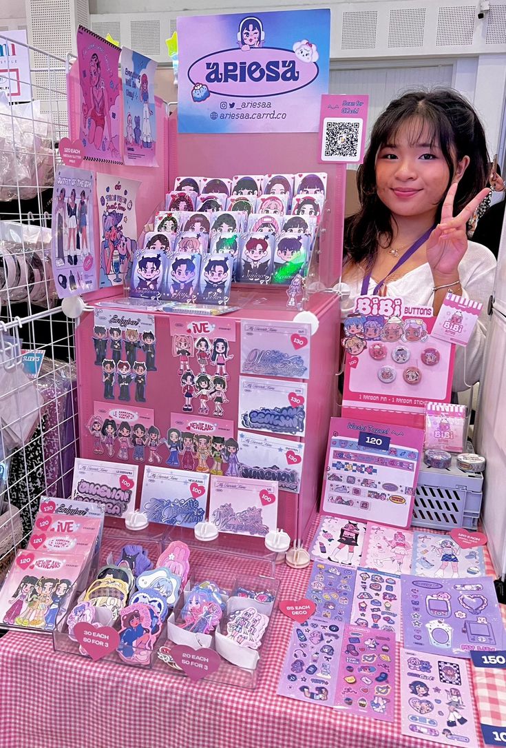 a woman standing in front of a table filled with cards and magnets on it