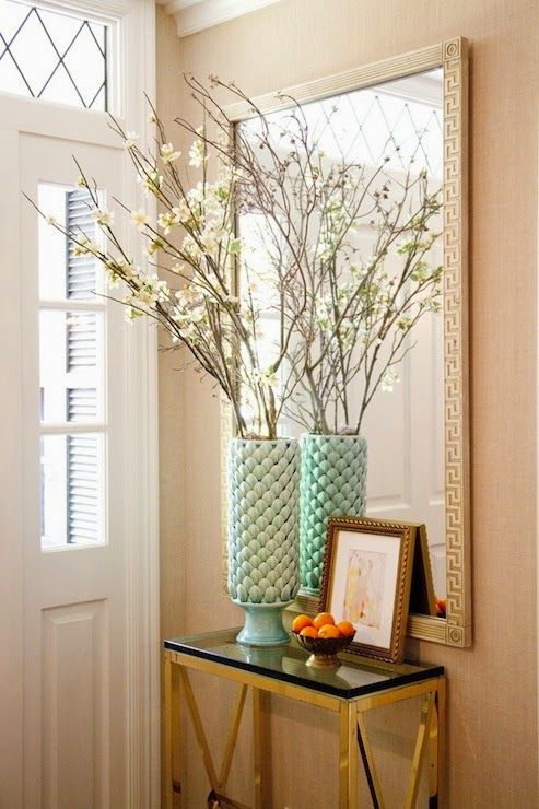 a vase filled with flowers sitting on top of a table next to a framed photo