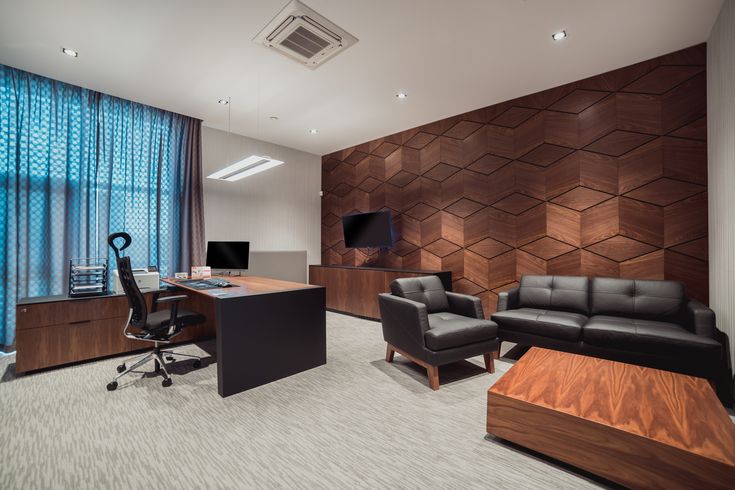 an office with leather furniture and wooden paneling