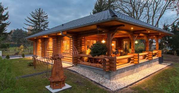 a small log cabin is lit up at night