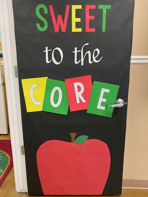 a classroom door decorated with the words sweet to the core and an apple on it