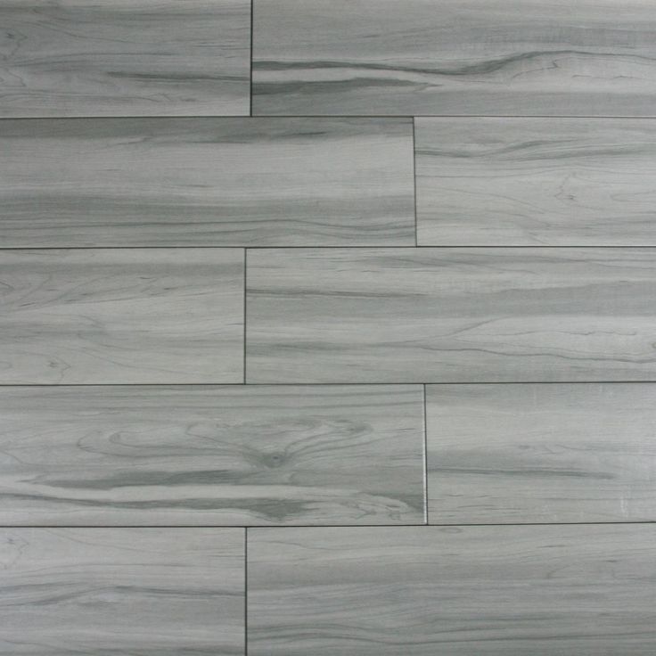 a white tile floor with grey wood grains on the sides and gray tiles on the other side