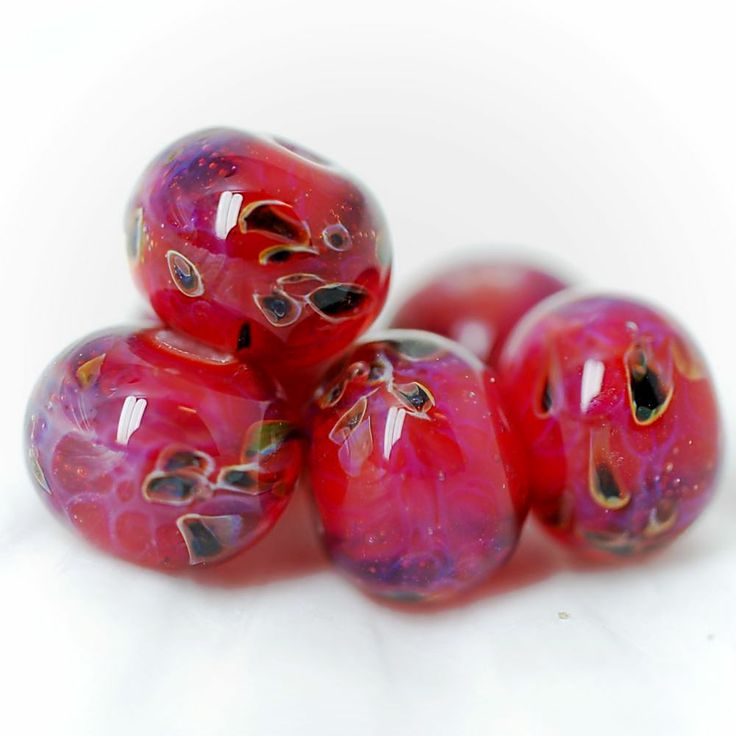 five red glass beads sitting on top of each other