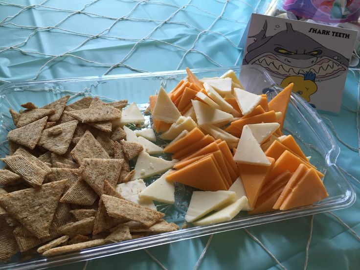 a plastic container filled with cheese and crackers