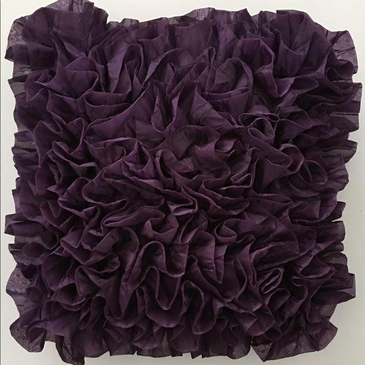 a purple pillow with ruffles on it