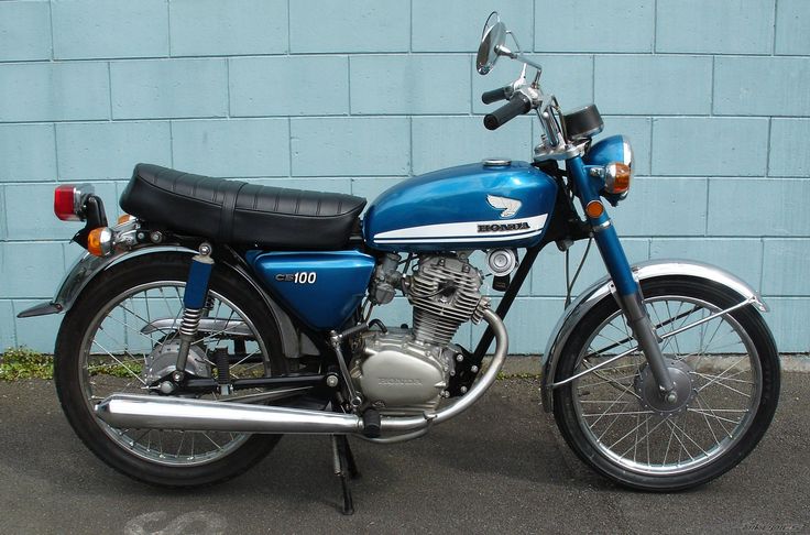 a blue motorcycle parked in front of a building