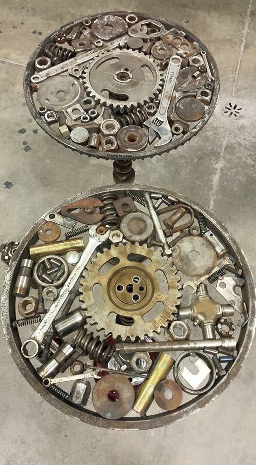 the inside of an old clock with gears and wrenches on it's sides