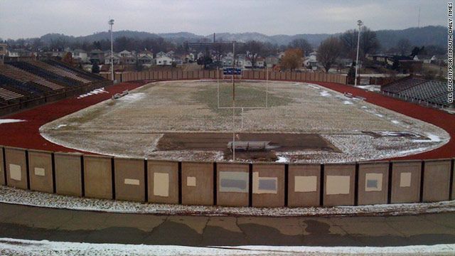 an empty baseball field with snow on the ground