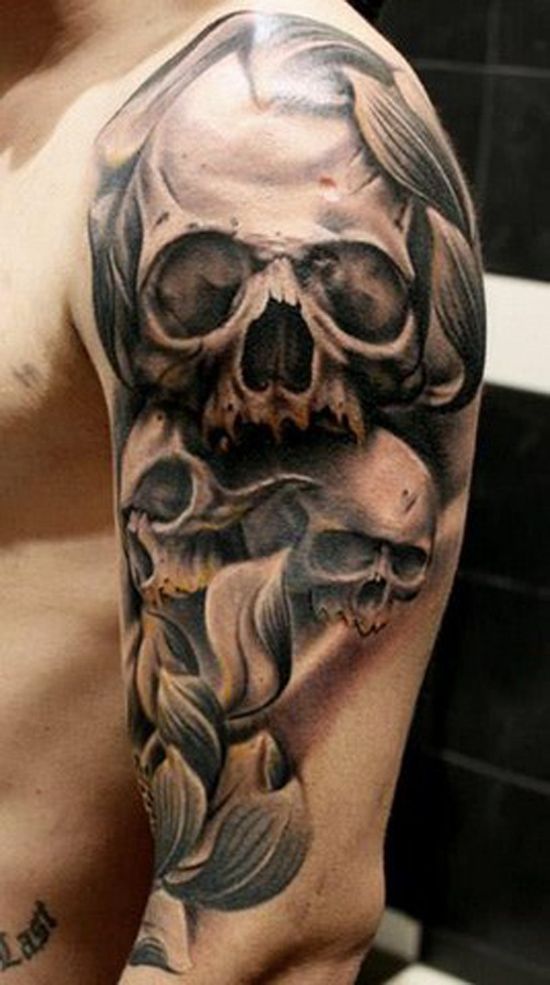 a man with a skull and fish tattoo on his arm