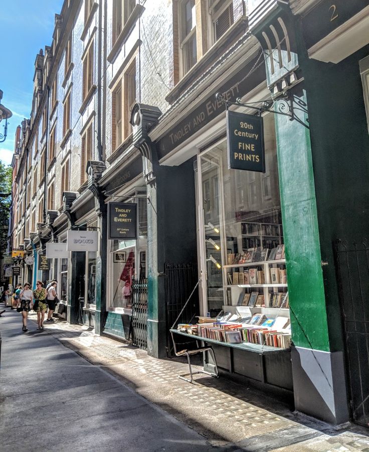 an empty street with books on display in the window