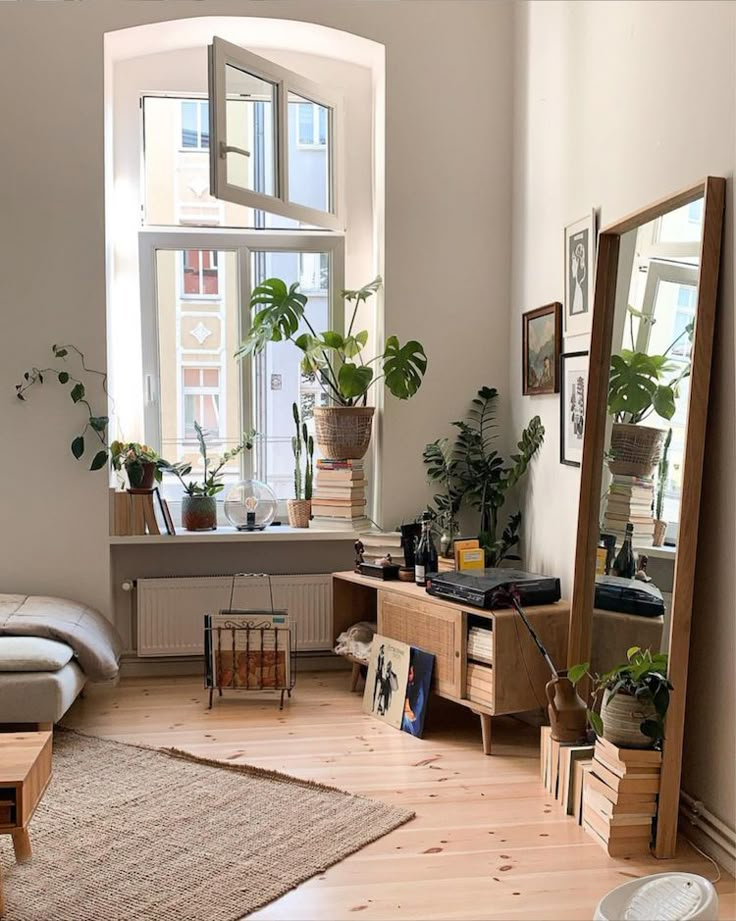 a living room filled with furniture and plants