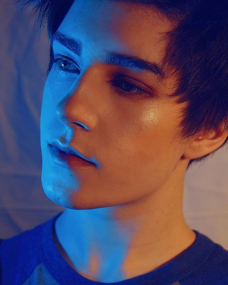 a young man with blue light on his face