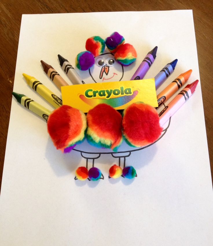 a card with crayons in the shape of a basket on top of it