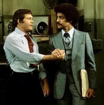 two men in suits shaking hands with each other