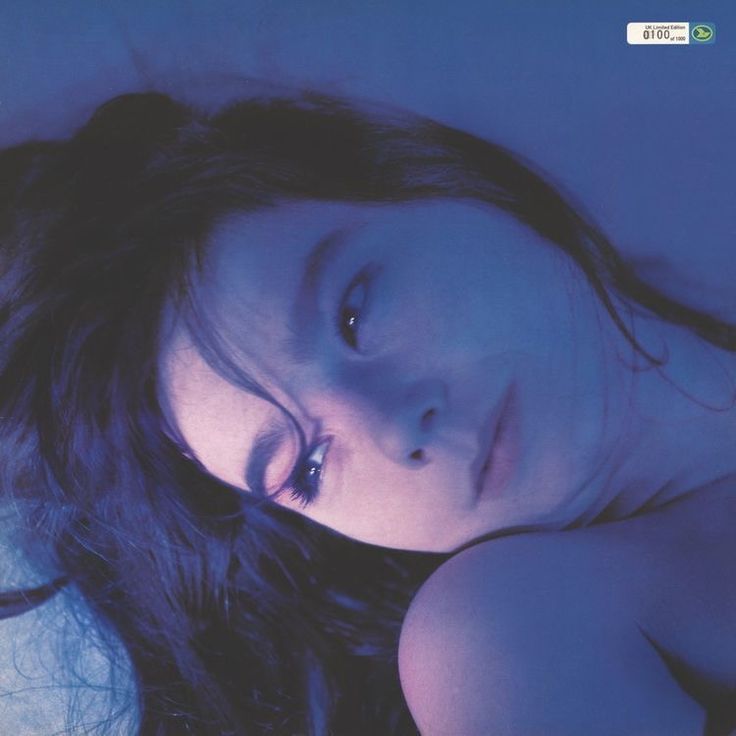 a woman laying down with her eyes closed