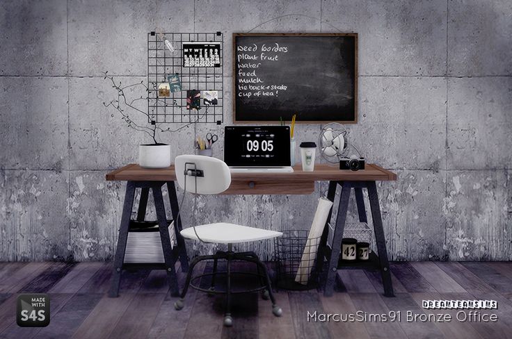 a computer desk with two chairs and a chalkboard on the wall