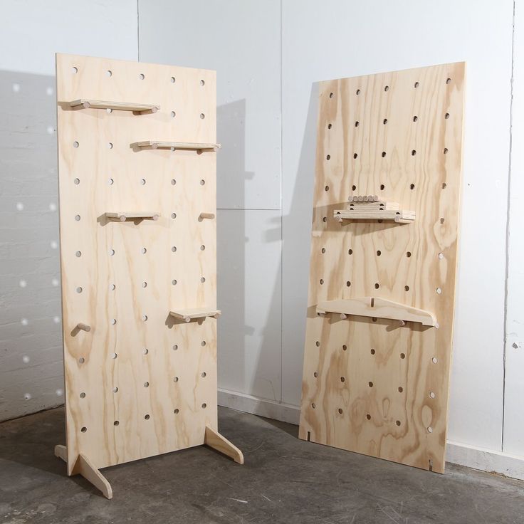 two pieces of plywood sit next to each other in a room with white walls