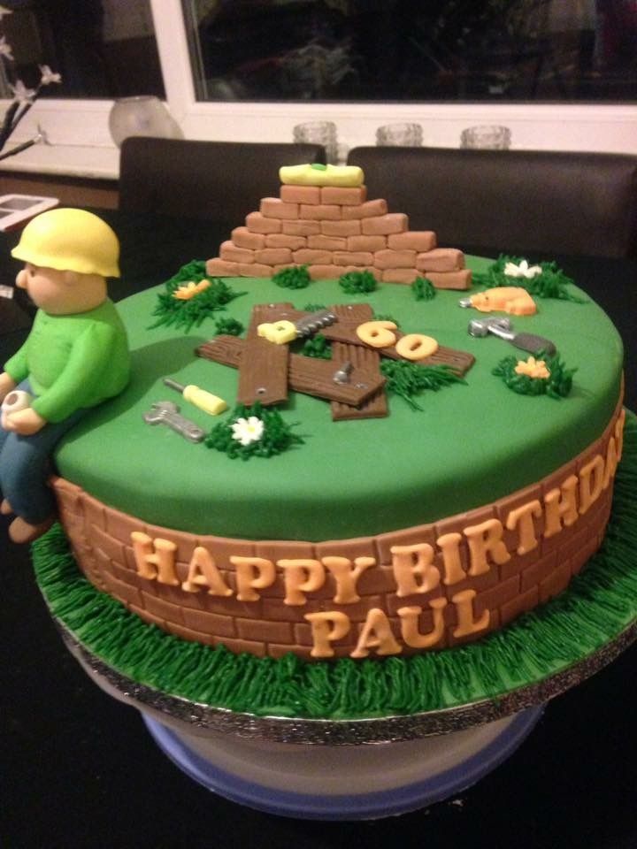 a birthday cake with a man sitting on top of it and the words happy birthday paul