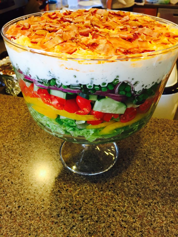 a colorful salad in a glass dish on a table