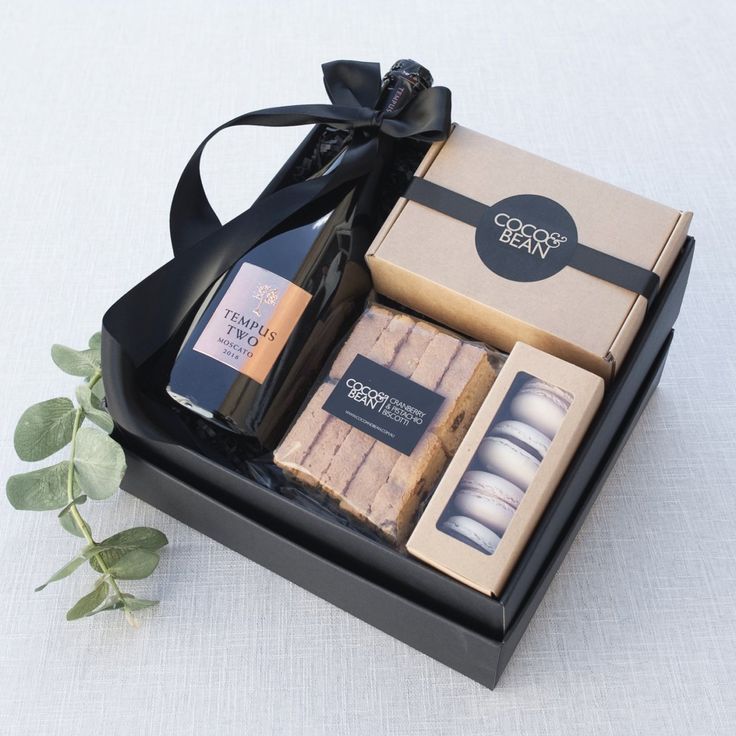 an open gift box containing soaps and candles