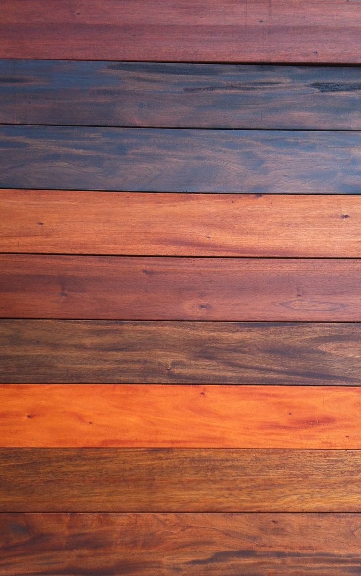 closeup of wood planks with different colors and patterns on them, as well as the background