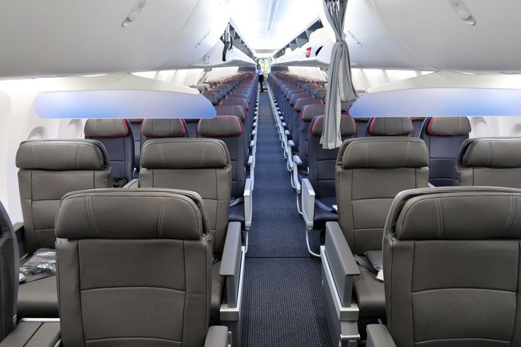 the inside of an airplane with rows of seats