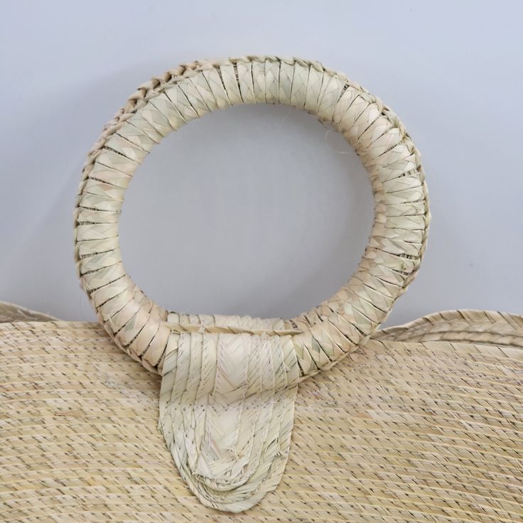 an old wicker bag with a knoted handle