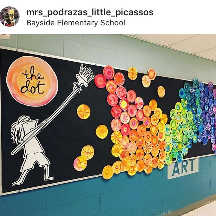 an art project is displayed on the wall in front of a school hallway with colorful artwork