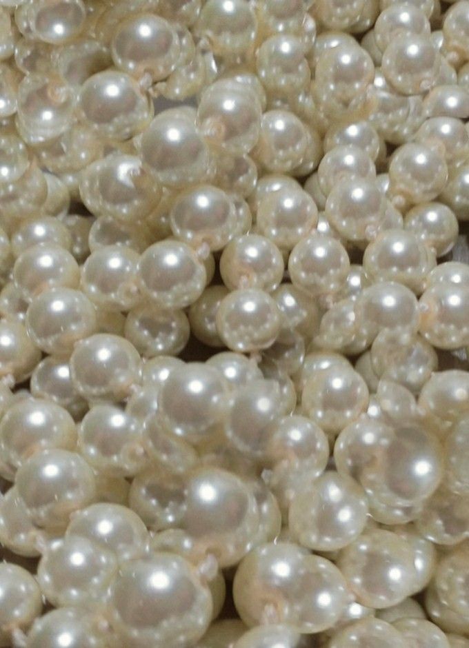 white pearls are piled together in a pile