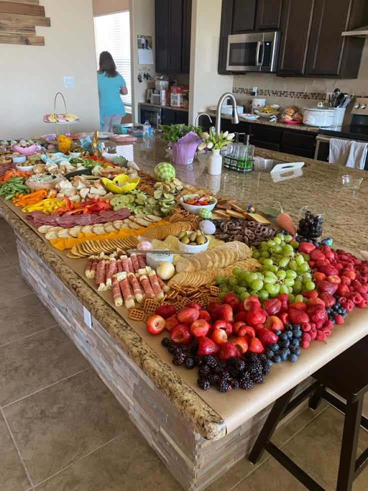 a kitchen island covered in fruit and vegetables