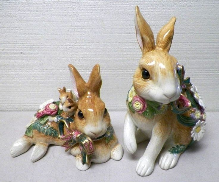 two ceramic rabbits sitting next to each other