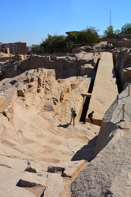 a man standing on top of a large rock formation