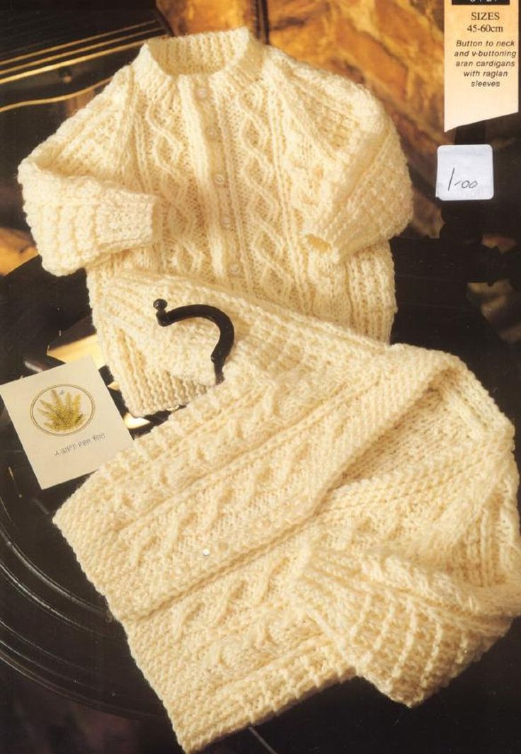 the knitting pattern for baby's sweater and hat is shown in white yarn with black letters