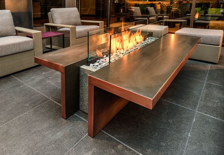 a fire pit sitting on top of a wooden table