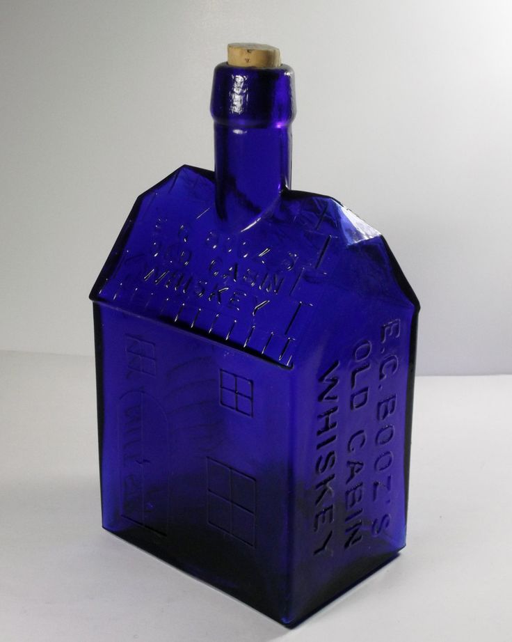 a blue glass bottle with writing on it