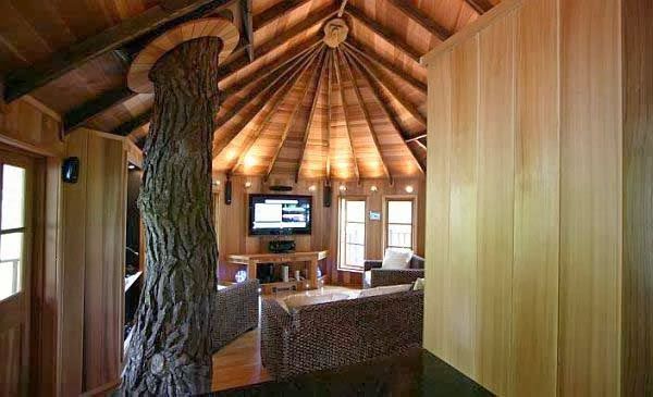 a living room with wood walls and ceiling