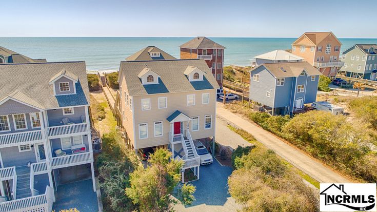 an aerial view of several beach houses near the ocean