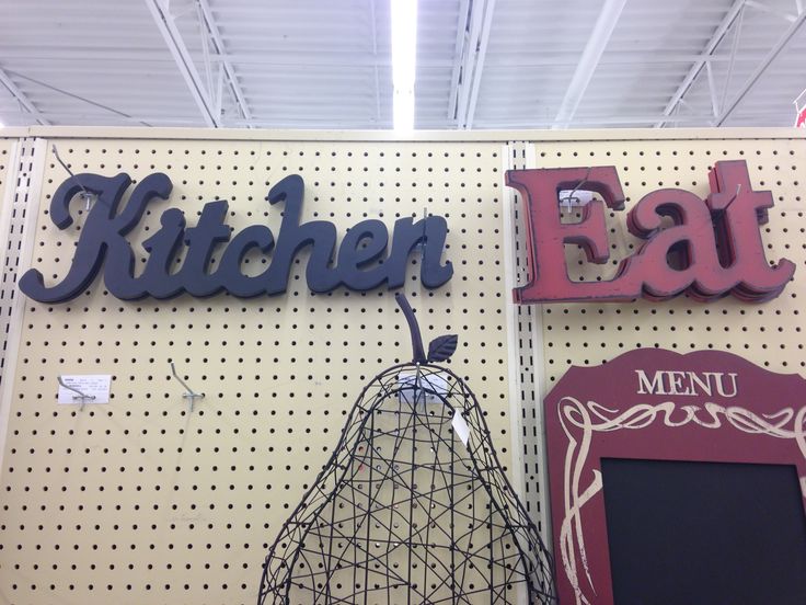 a sign that says kitchen eat next to a menu