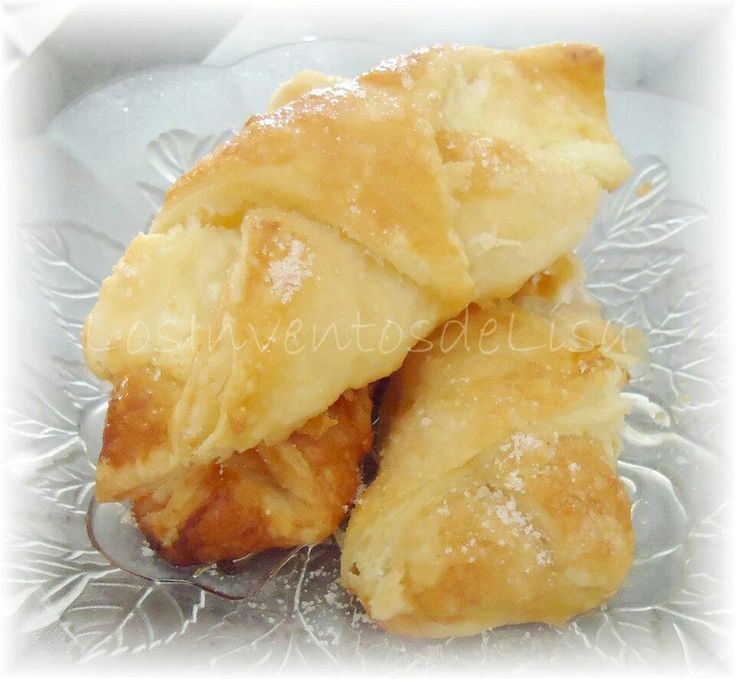 three pastries sitting on top of a glass plate